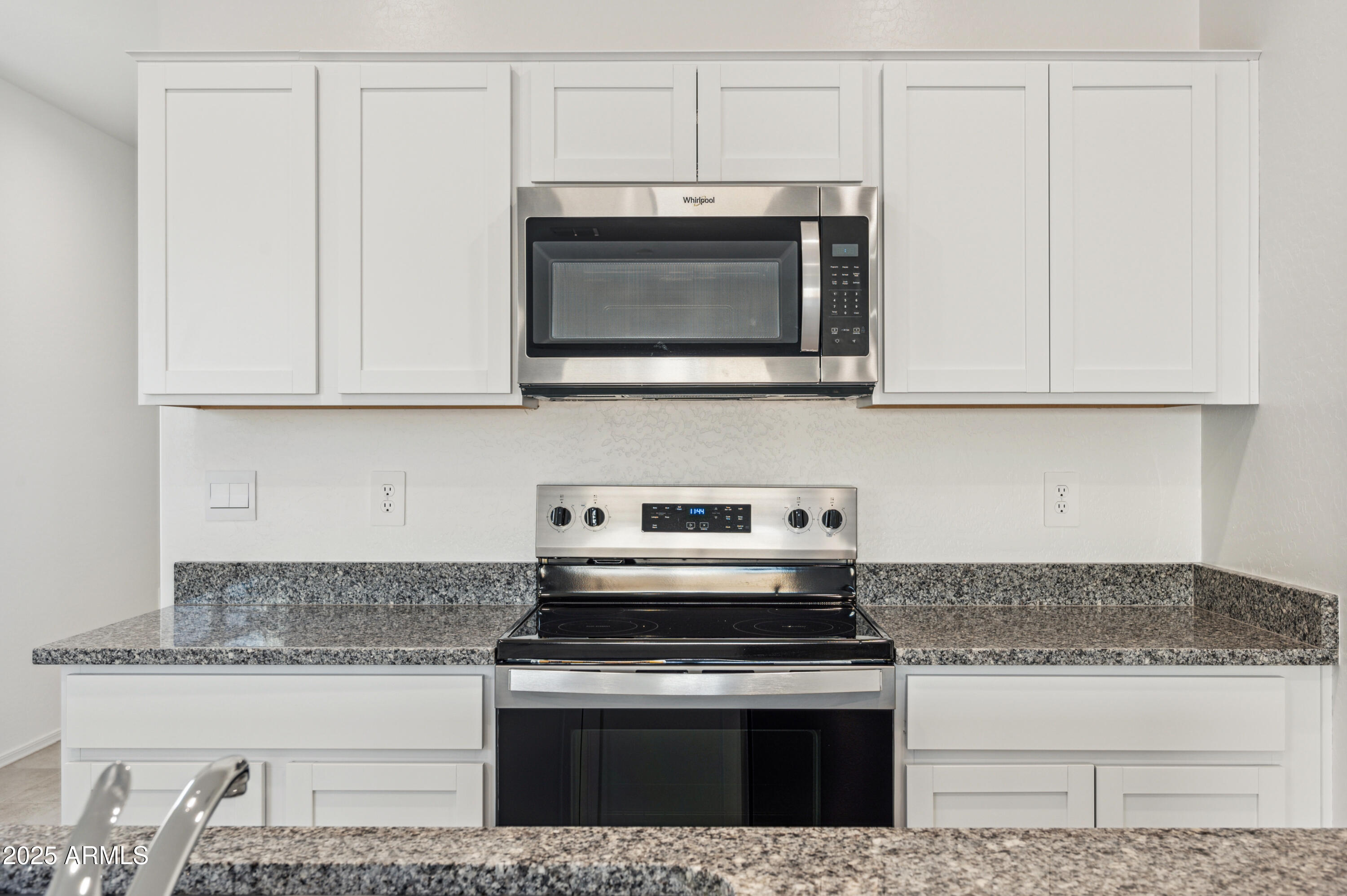 5072 East Umber Road San Tan Valley, AZ 85143 - Photo 13 of 41 a kitchen with granite countertop a stove and a microwave