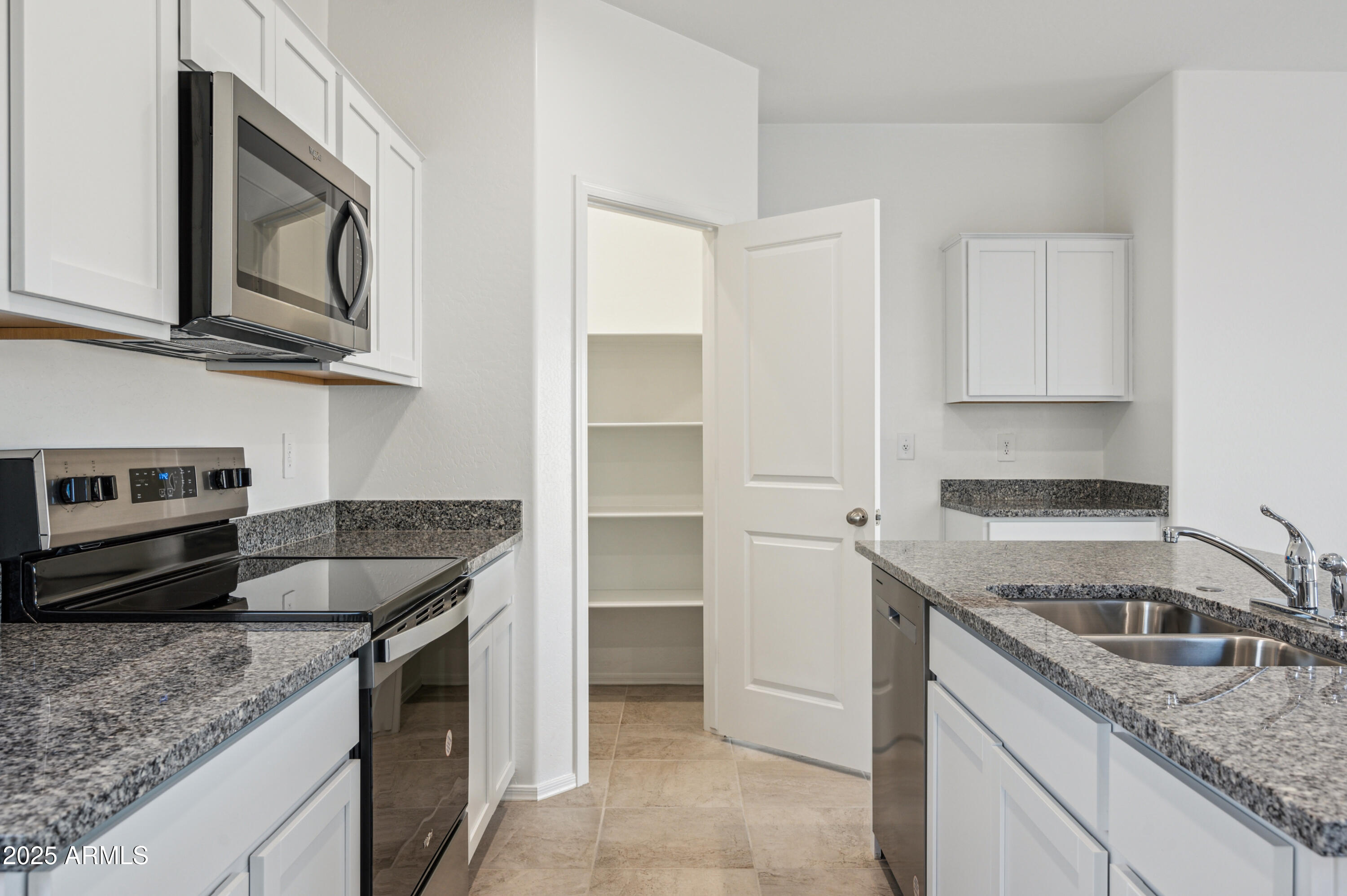 5072 East Umber Road San Tan Valley, AZ 85143 - Photo 14 of 41 a kitchen with granite countertop a sink and stainless steel appliances