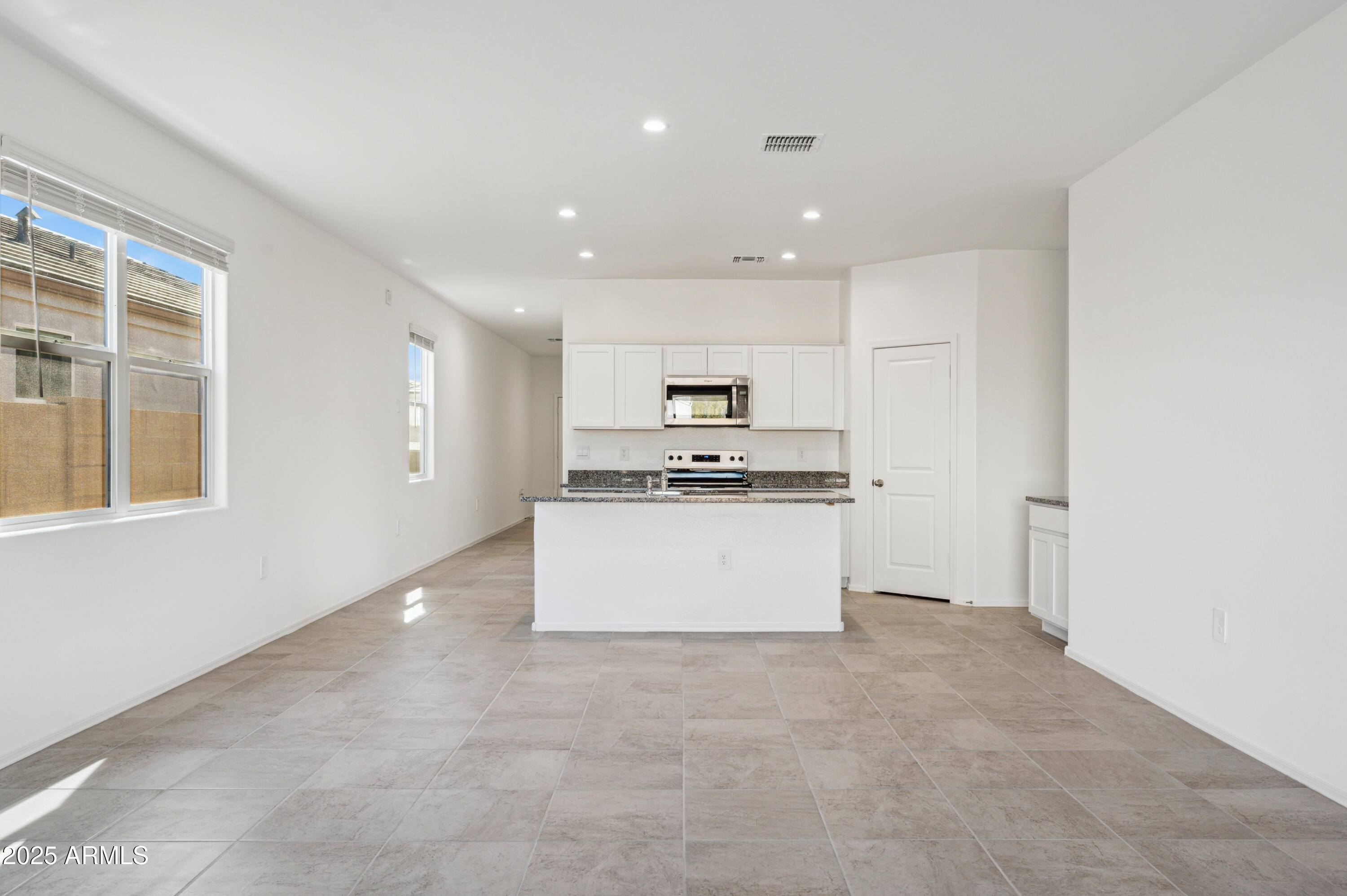 5072 East Umber Road San Tan Valley, AZ 85143 - Photo 17 of 41 a view of kitchen with kitchen island white cabinets and refrigerator