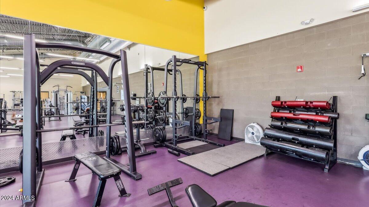 5072 East Umber Road San Tan Valley, AZ 85143 - Photo 34 of 41 a bedroom with furniture and gym equipment