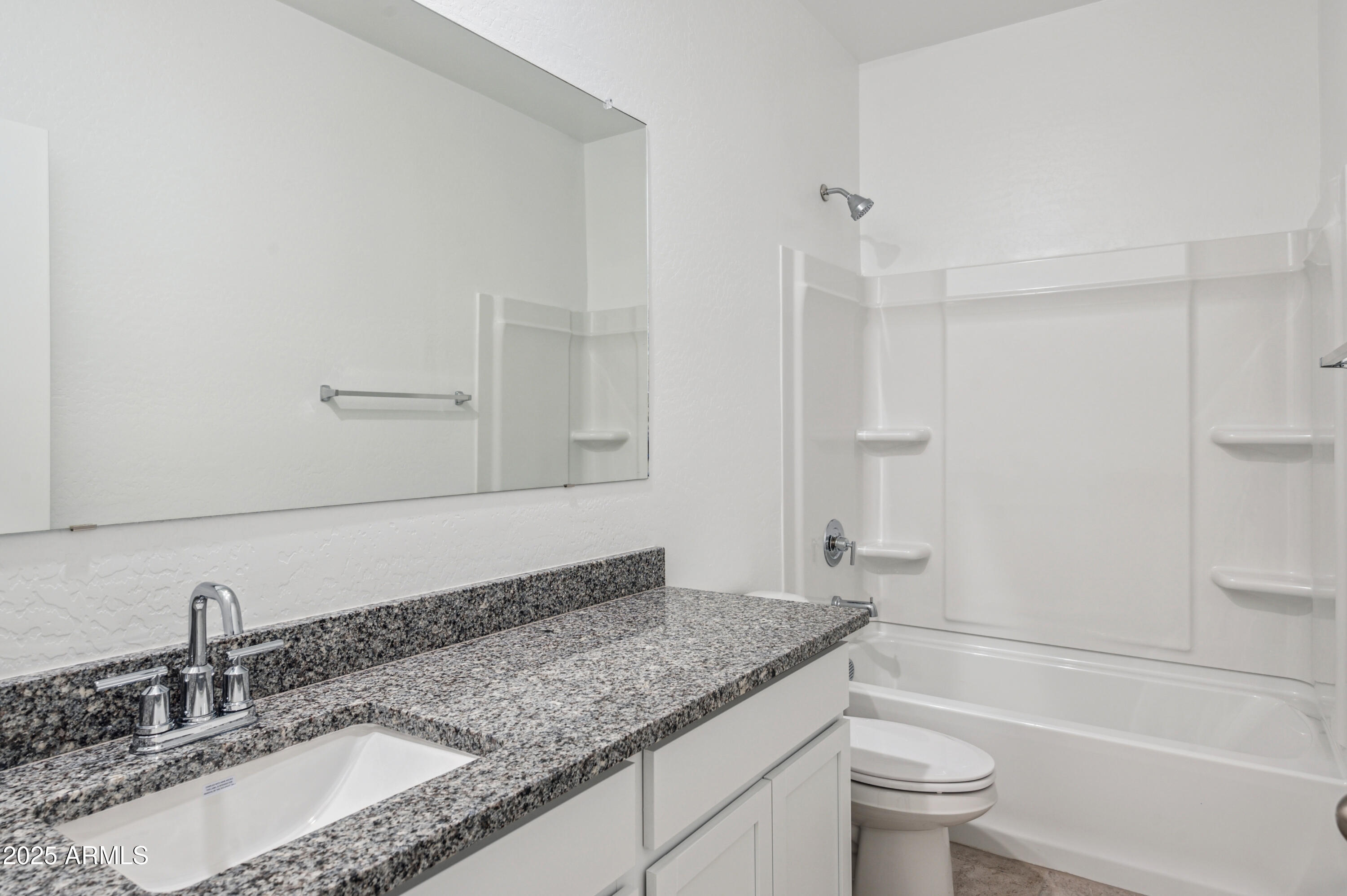 5072 East Umber Road San Tan Valley, AZ 85143 - Photo 6 of 41 a bathroom with a granite countertop sink a toilet and bathtub