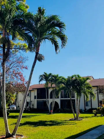 a view of a house with swimming pool and a yard