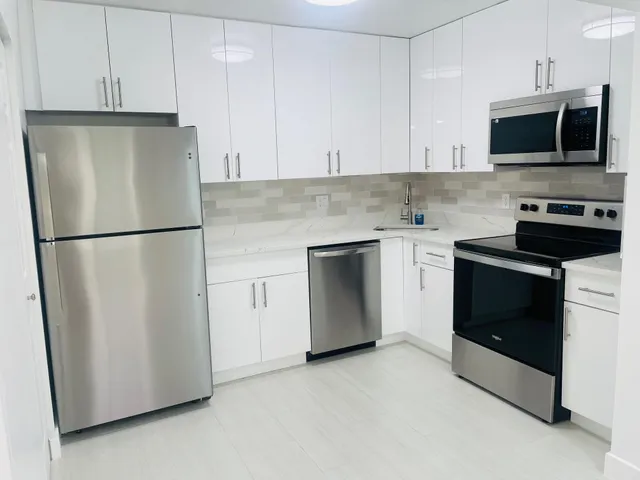 an empty room with fan and entrance