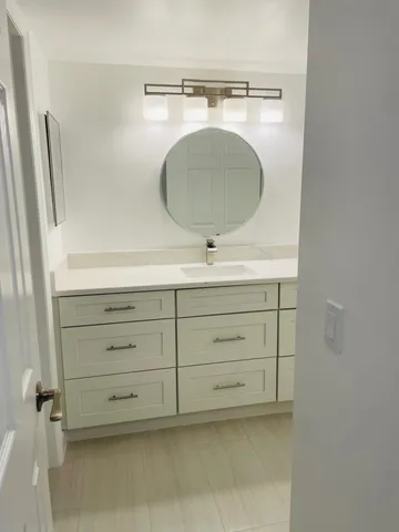 a bathroom with a sink toilet and mirror