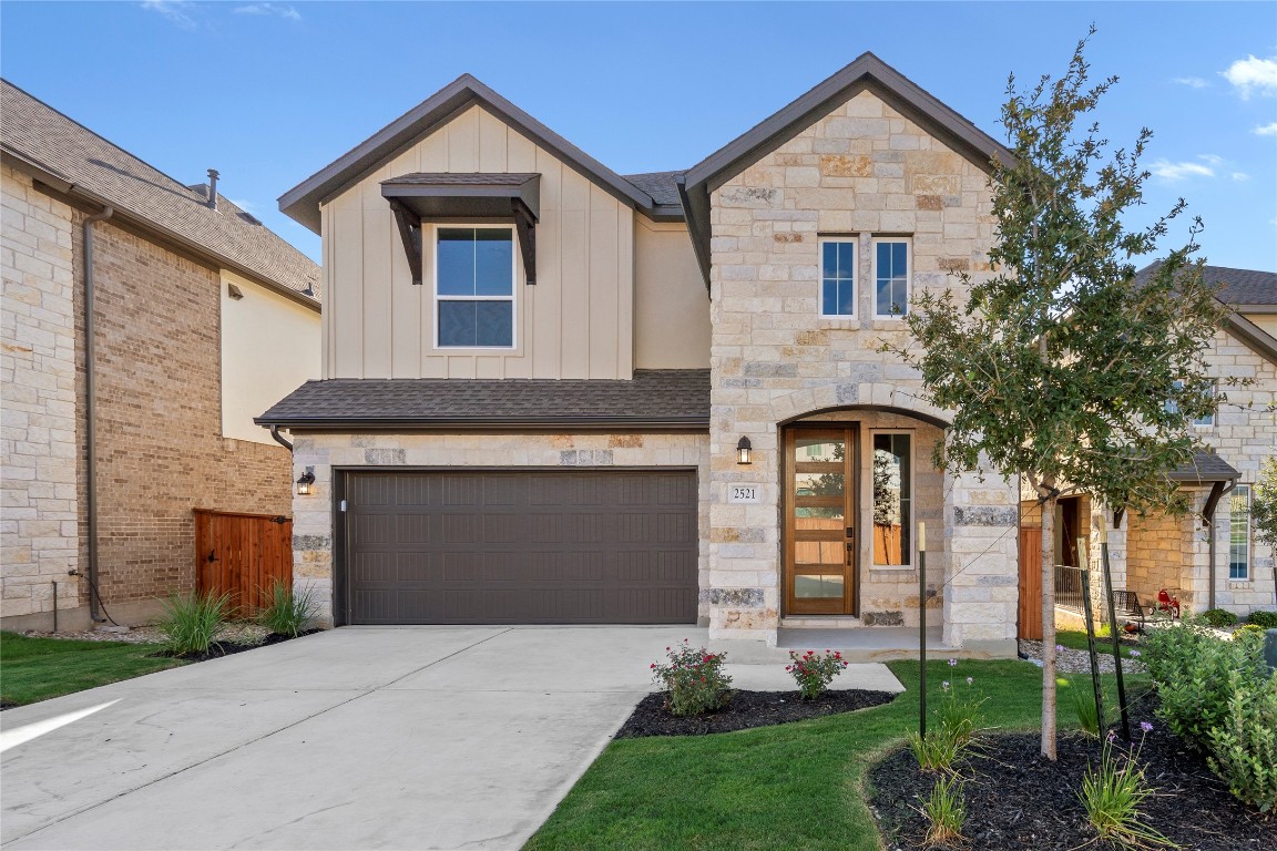 a front view of a house with a yard and garage
