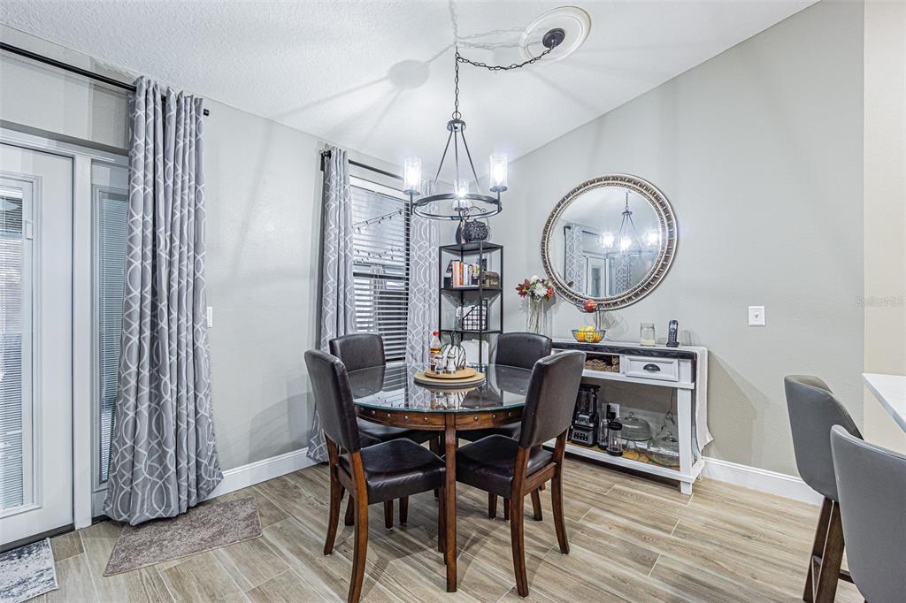 9809 La Rita Place Riverview, FL 33569 - Photo 25 of 59 a dining room with furniture a chandelier and wooden floor