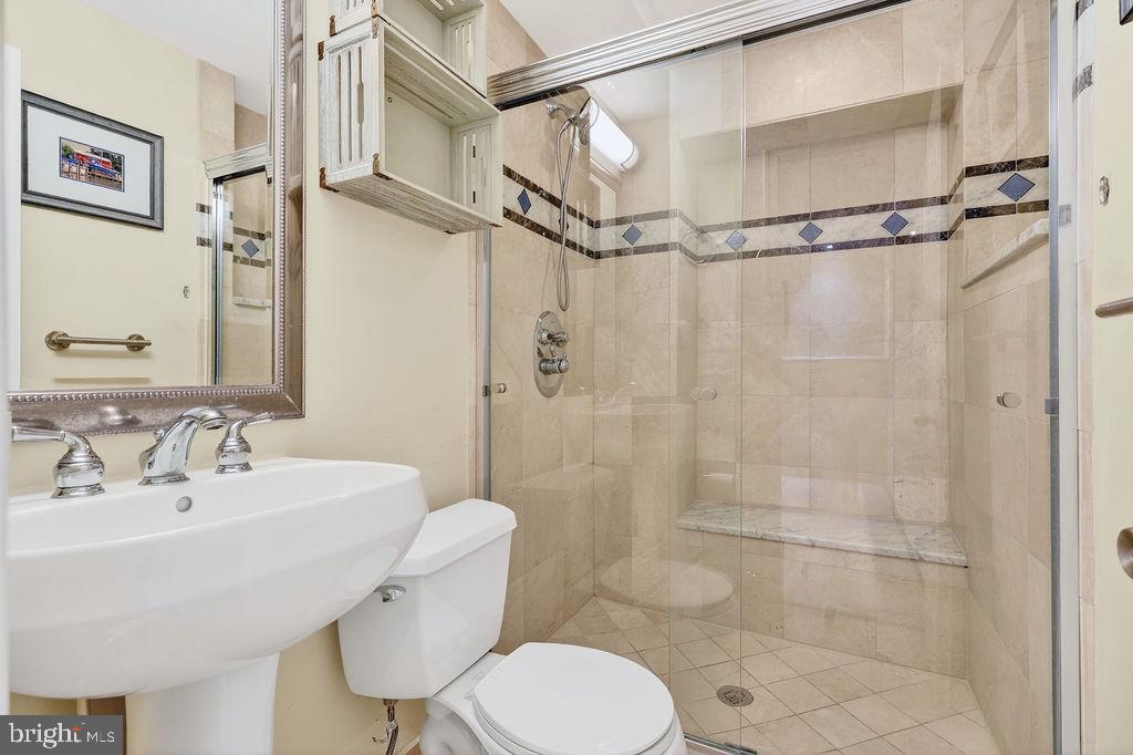 8471 Great Lake Lane Springfield, VA 22153 - Photo 34 of 65 a bathroom with a toilet a sink and shower