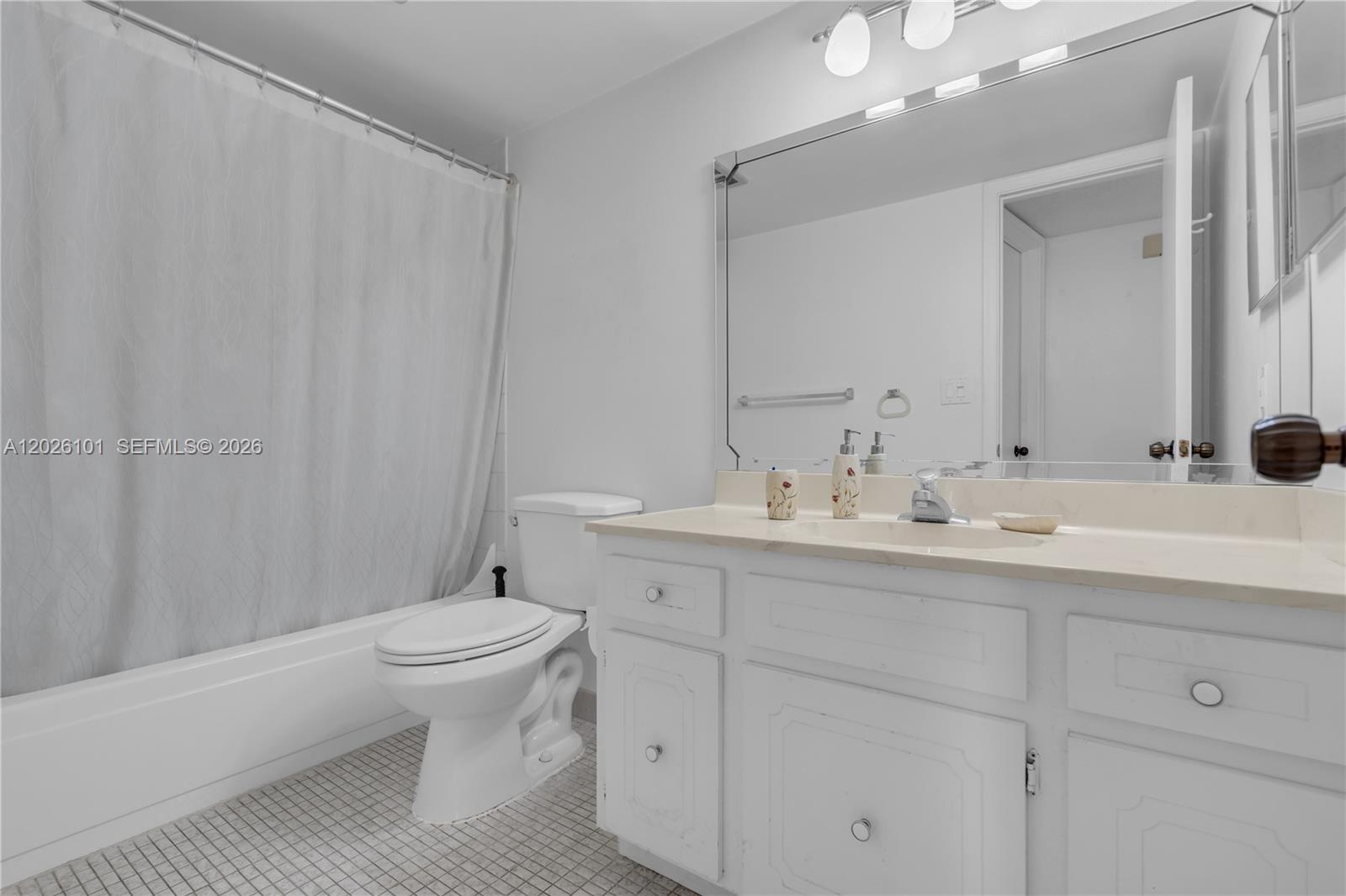 3551 Inverrary Drive, Unit 208 Lauderhill, FL 33319 - Photo 15 of 34 a bathroom with a toilet a sink and mirror