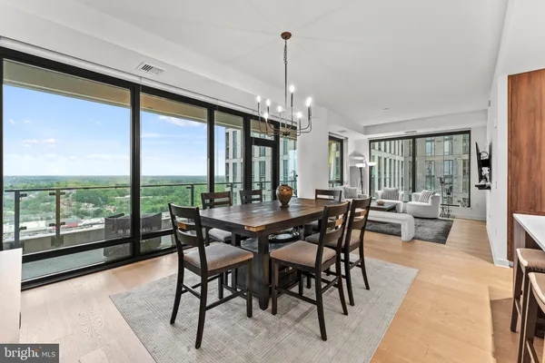 a view of a livingroom with furniture and floor to ceiling window
