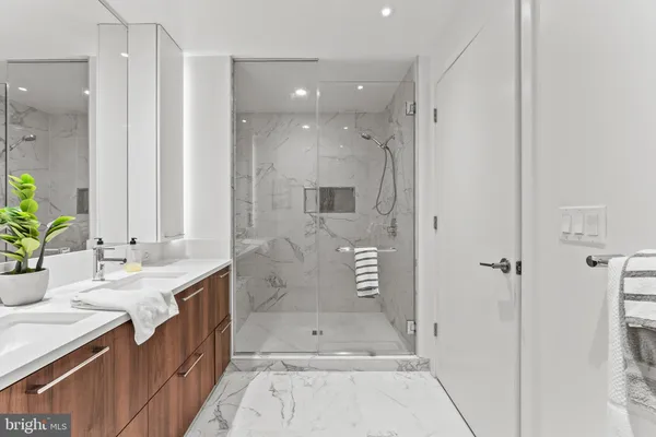 a bathroom with a double vanity sink toilet and shower