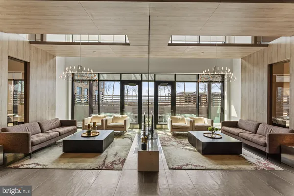a view of a dining room with furniture large windows and wooden floor