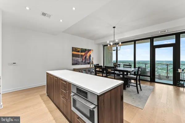 a living room with furniture a flat screen tv and a large window