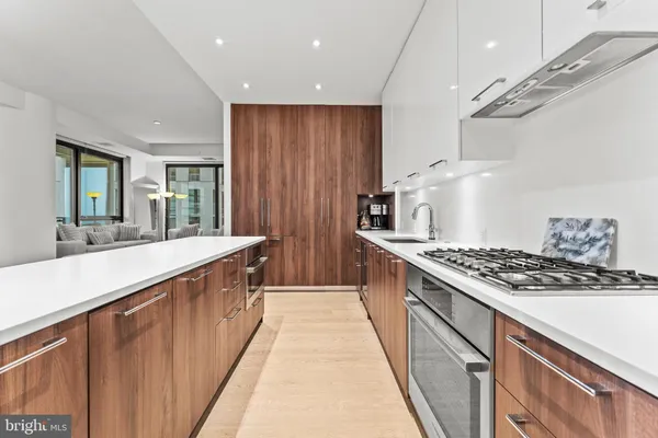 a kitchen with stainless steel appliances a stove and white cabinets