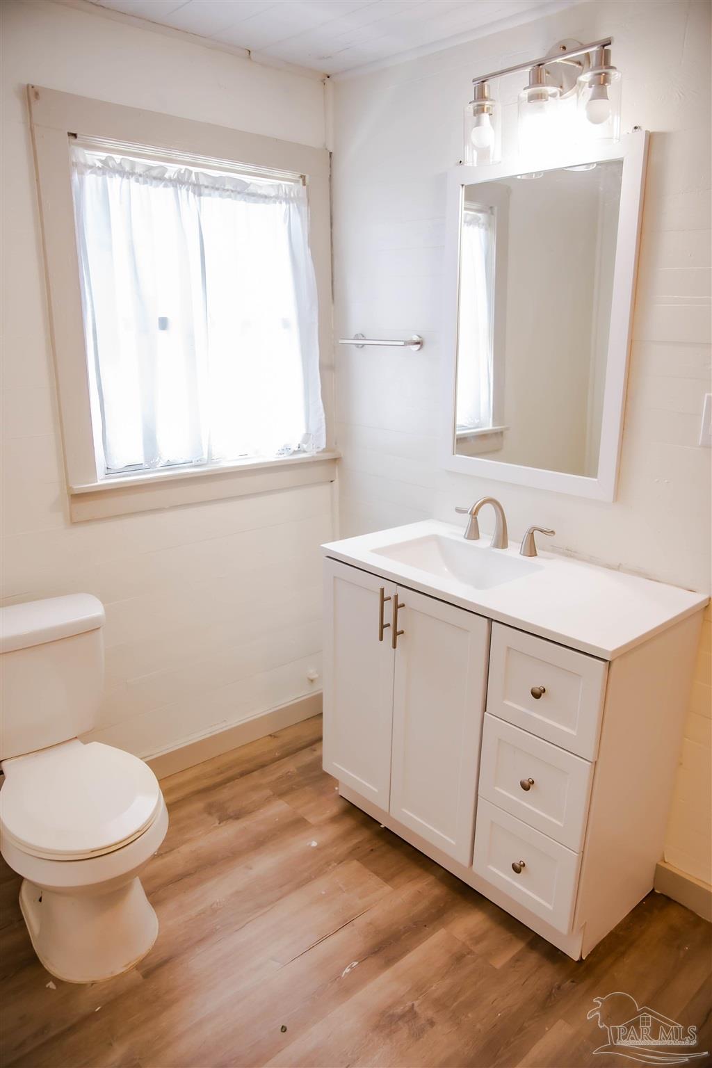 5347 Stewart Street Milton, FL 32570 - Photo 18 of 20 a bathroom with a toilet sink and mirror