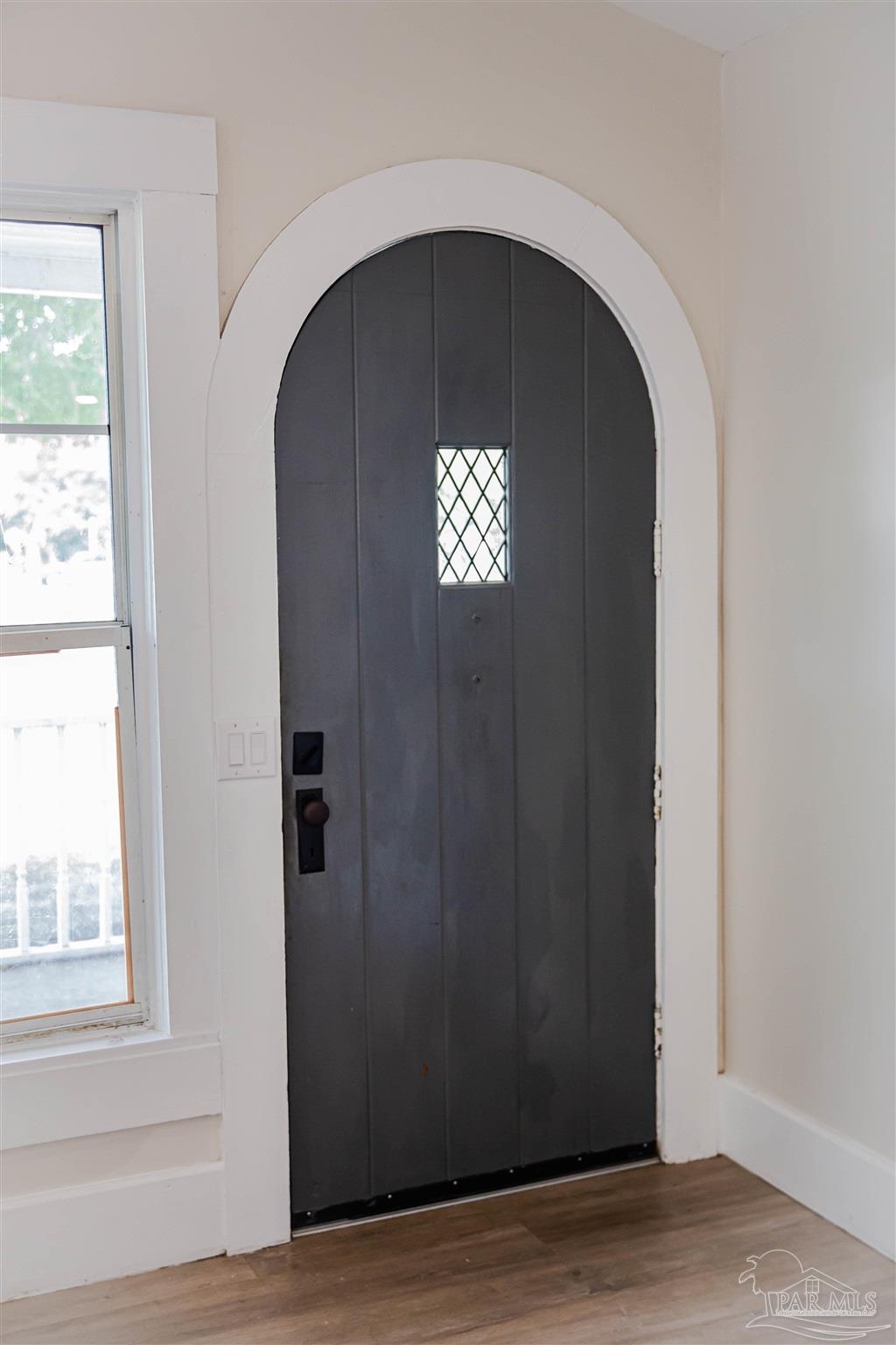 5347 Stewart Street Milton, FL 32570 - Photo 4 of 20 an empty room with wooden floor windows and entryway