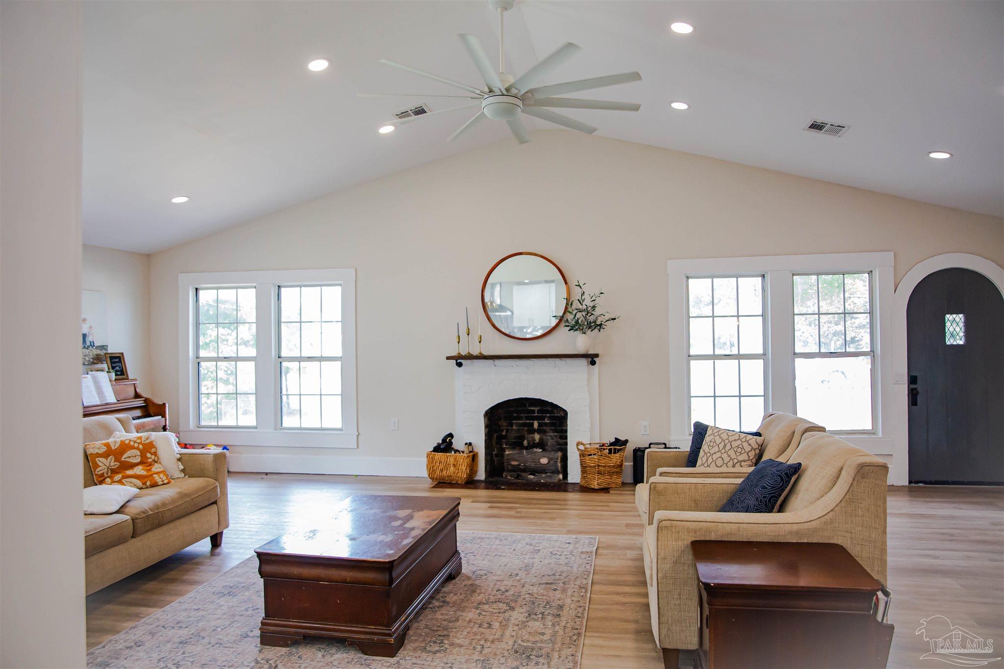 5347 Stewart Street Milton, FL 32570 - Photo 9 of 20 a living room with furniture a fireplace and a large window