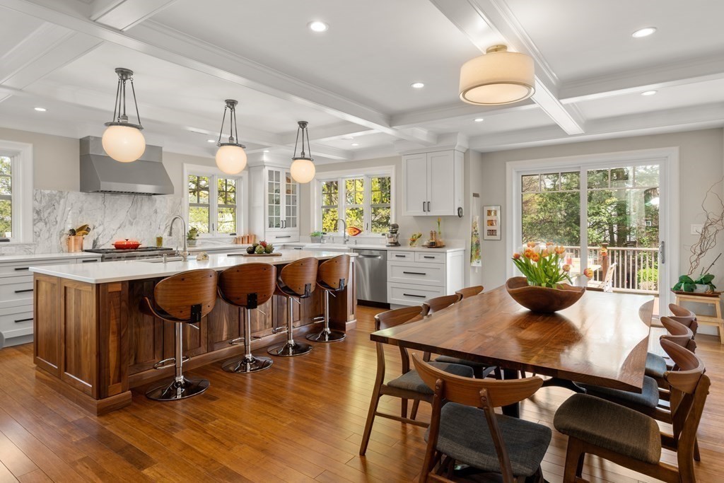 a kitchen with kitchen island granite countertop a table and chairs in it