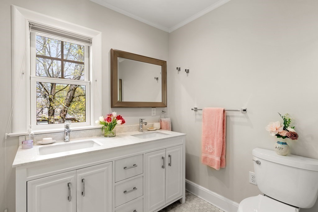 28 Sheffield Road Newton, MA 02465 - Photo 23 of 39 a bathroom with a double vanity sink and a mirror