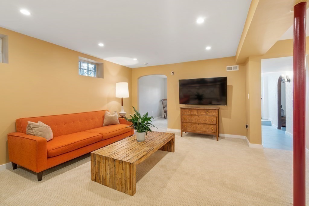 28 Sheffield Road Newton, MA 02465 - Photo 32 of 39 a living room with furniture and a flat screen tv