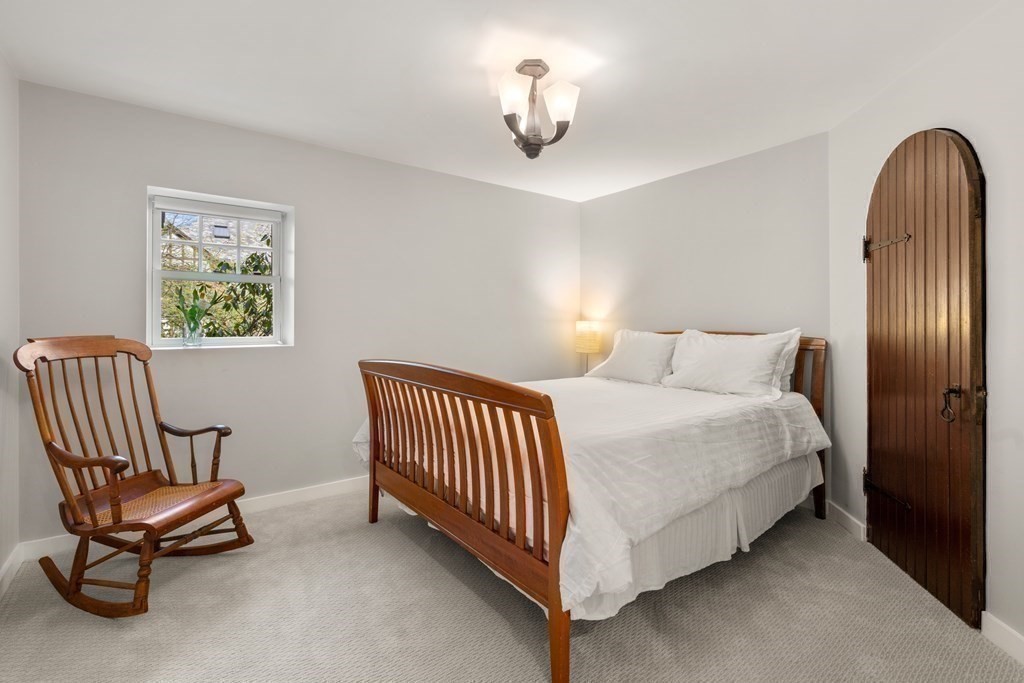 28 Sheffield Road Newton, MA 02465 - Photo 33 of 39 a bedroom with a bed and a chair