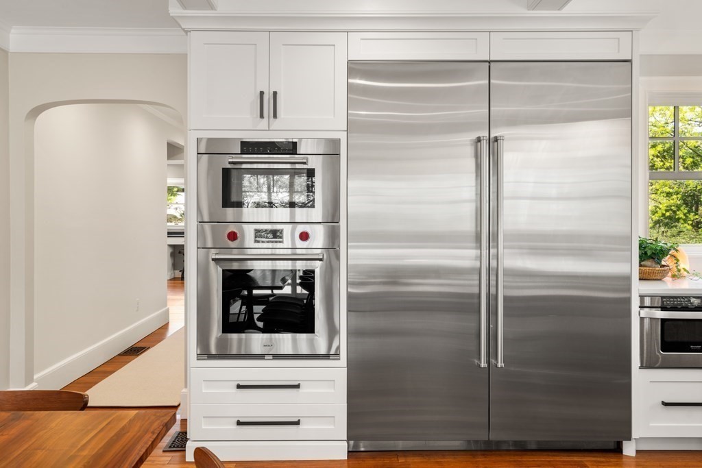 28 Sheffield Road Newton, MA 02465 - Photo 5 of 39 a kitchen with stainless steel appliances wooden floor and a fireplace