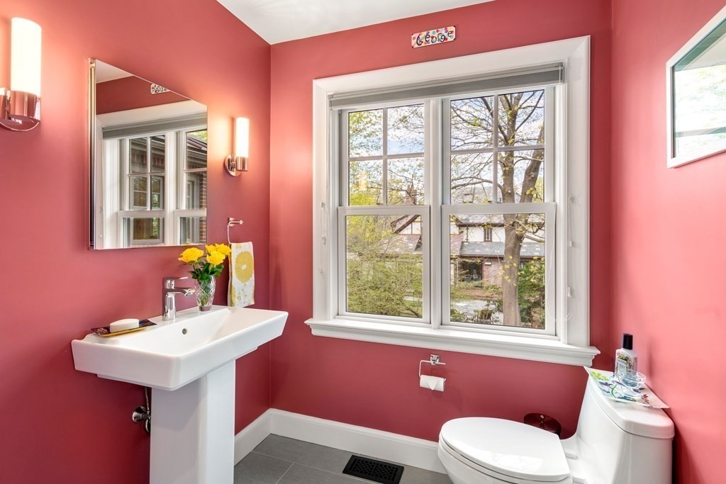 28 Sheffield Road Newton, MA 02465 - Photo 8 of 39 a bathroom with a sink a mirror a window and a toilet
