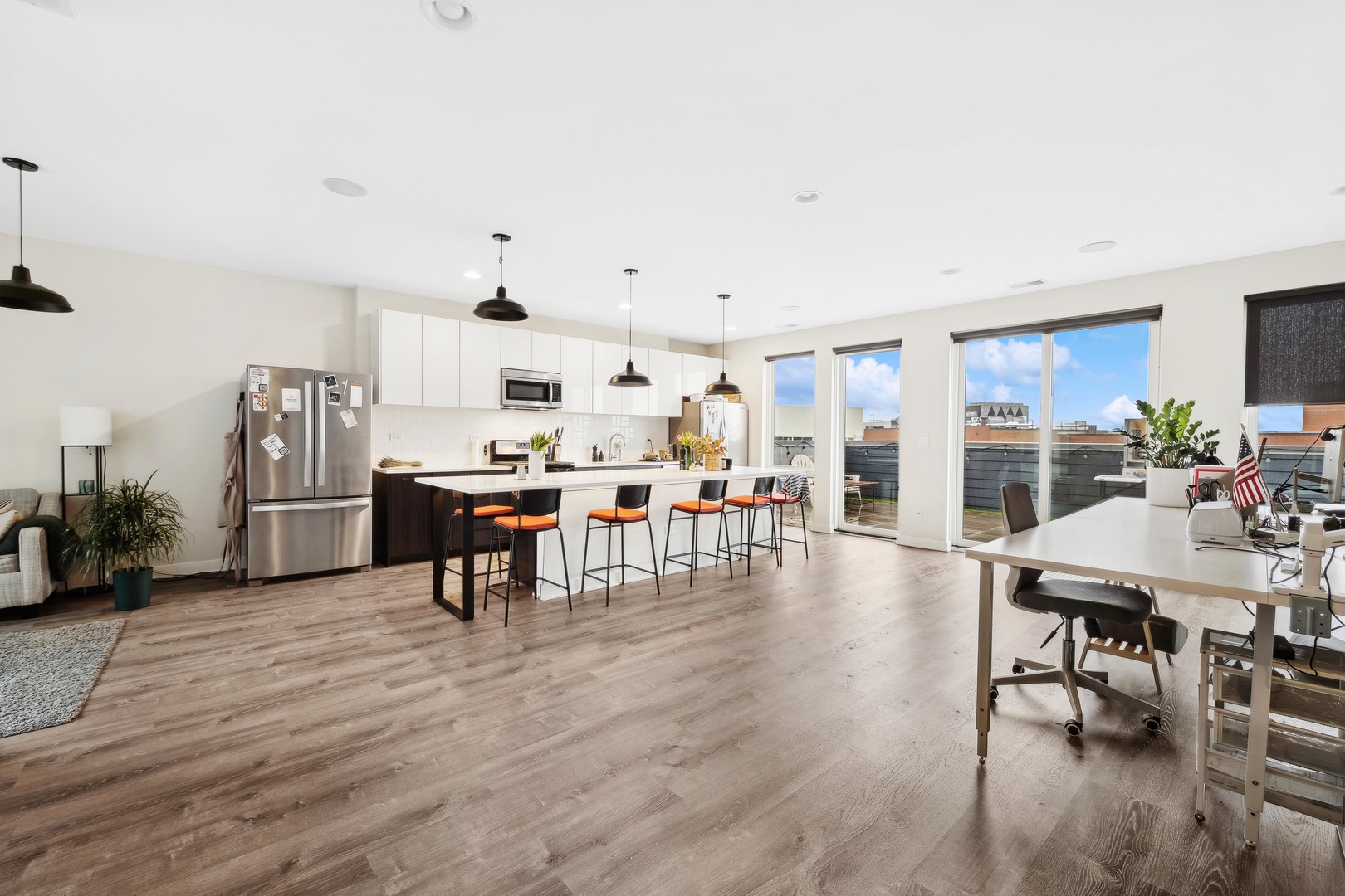 4027 North Broadway Chicago, IL 60613 - Photo 14 of 25 a living room with lots of furniture and kitchen view