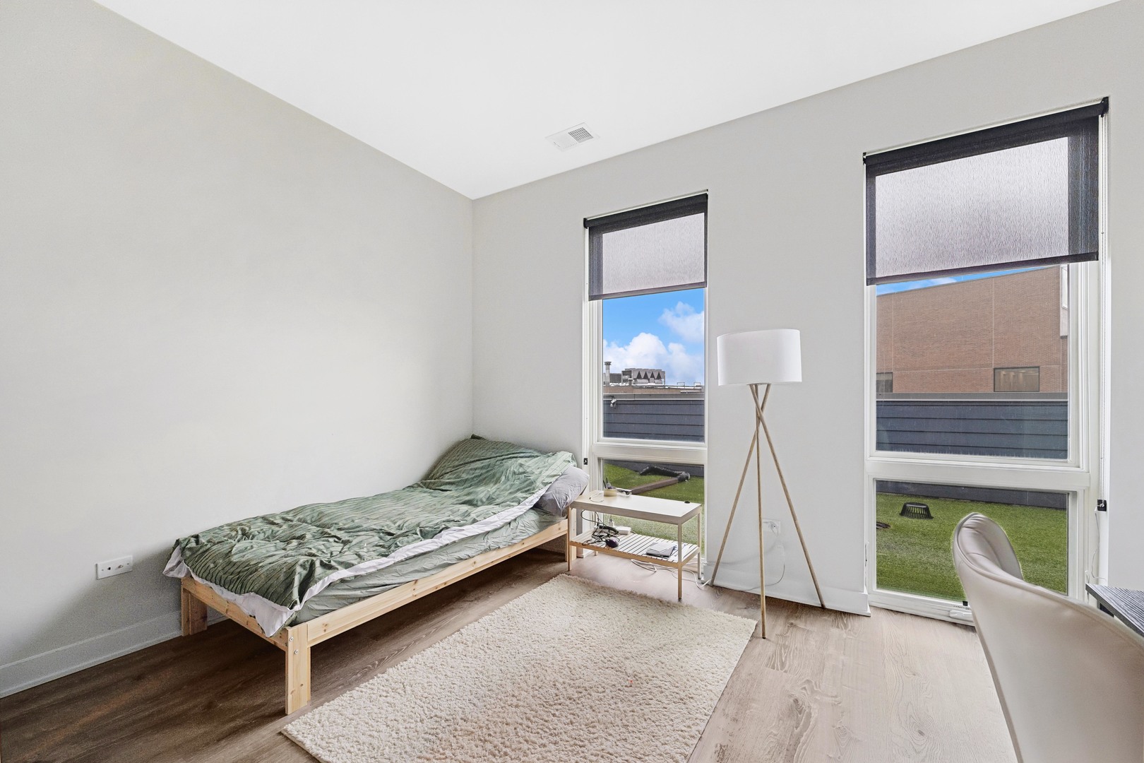 4027 North Broadway Chicago, IL 60613 - Photo 20 of 25 a bedroom with a bed and a window