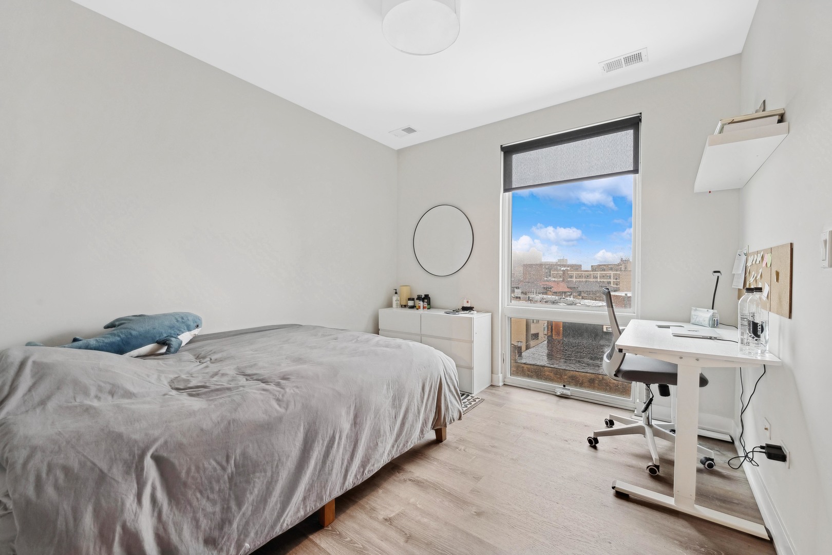 4027 North Broadway Chicago, IL 60613 - Photo 23 of 25 a bedroom with a bed and wooden floor