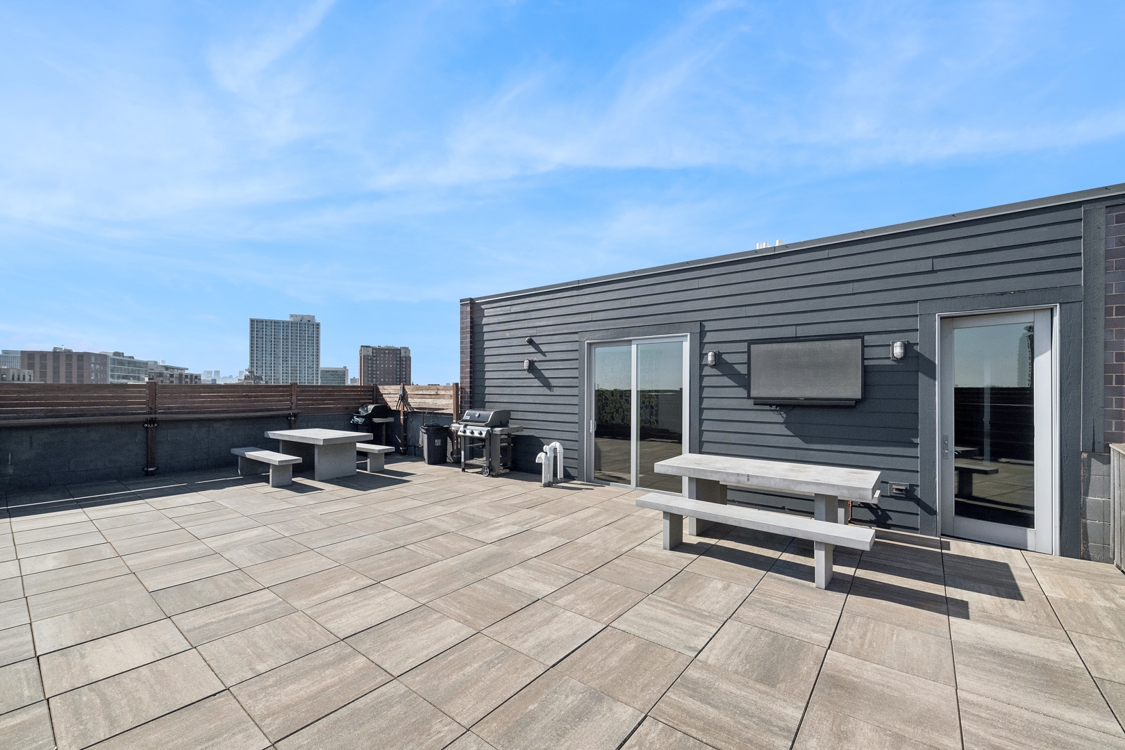 4027 North Broadway Chicago, IL 60613 - Photo 7 of 25 a view of roof deck with outdoor seating and city view