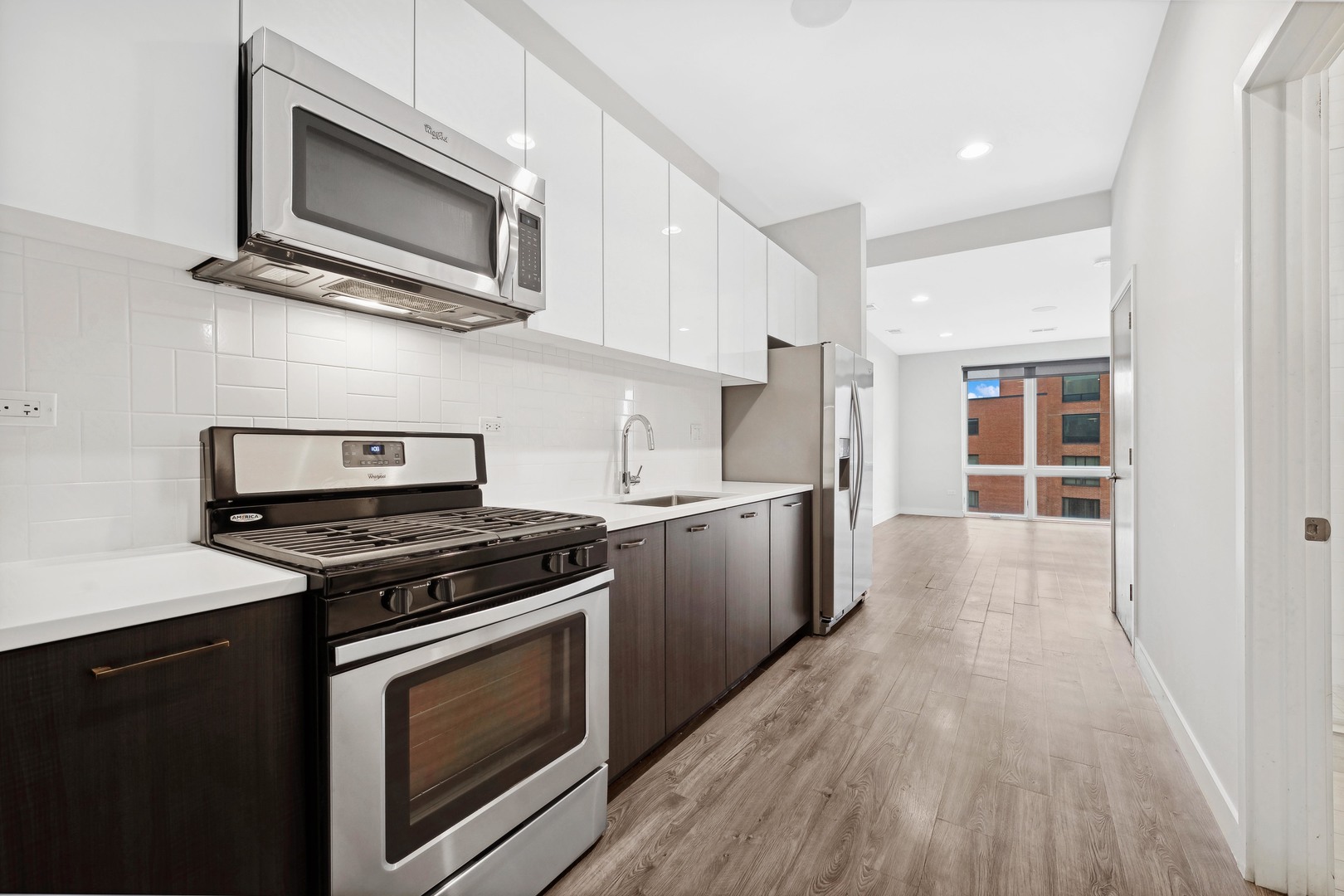 4027 North Broadway Chicago, IL 60613 - Photo 9 of 25 a kitchen with stainless steel appliances a stove microwave and sink