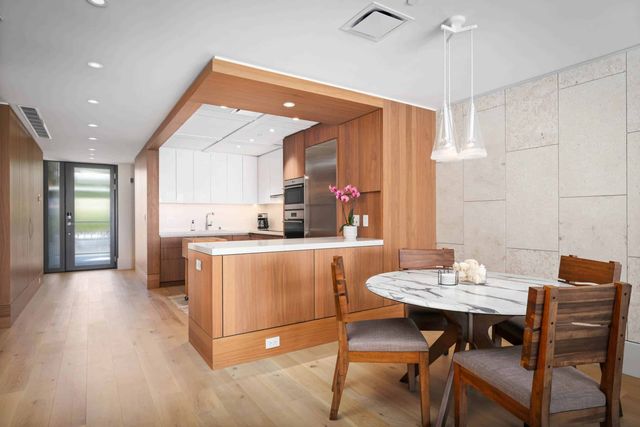 a kitchen with a table chairs sink and cabinets