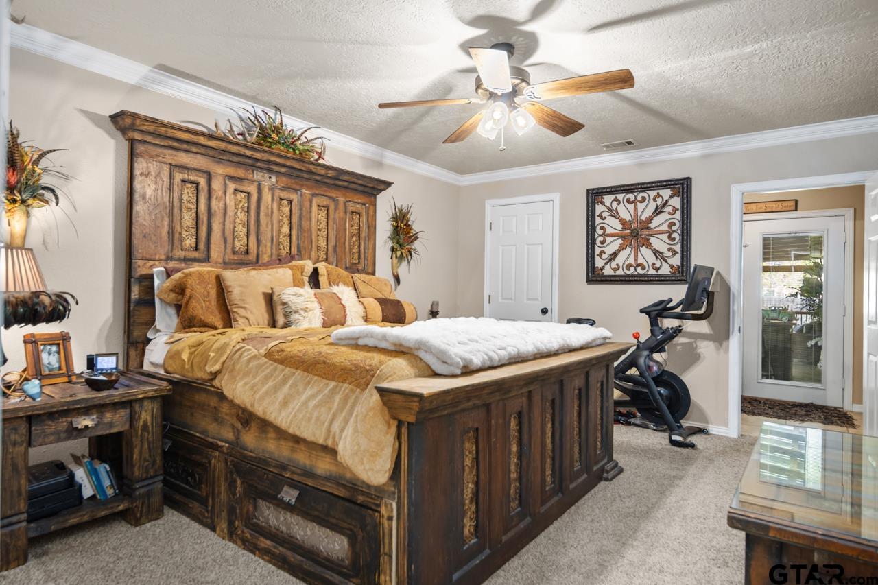 751 Houston Street Lovelady, TX 75851 - Photo 15 of 25 a bedroom with a bed and a chandelier