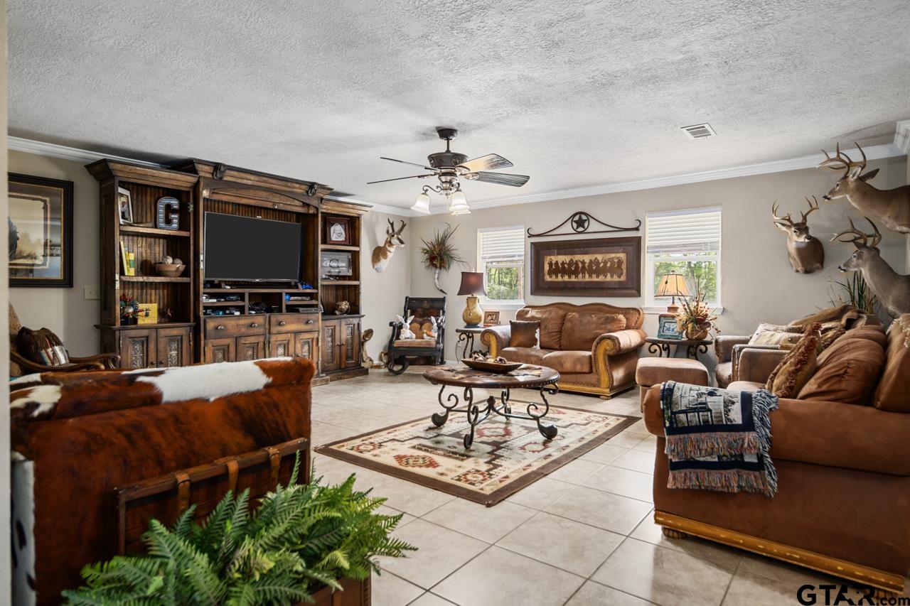 751 Houston Street Lovelady, TX 75851 - Photo 8 of 25 a living room with furniture a fireplace and a flat screen tv