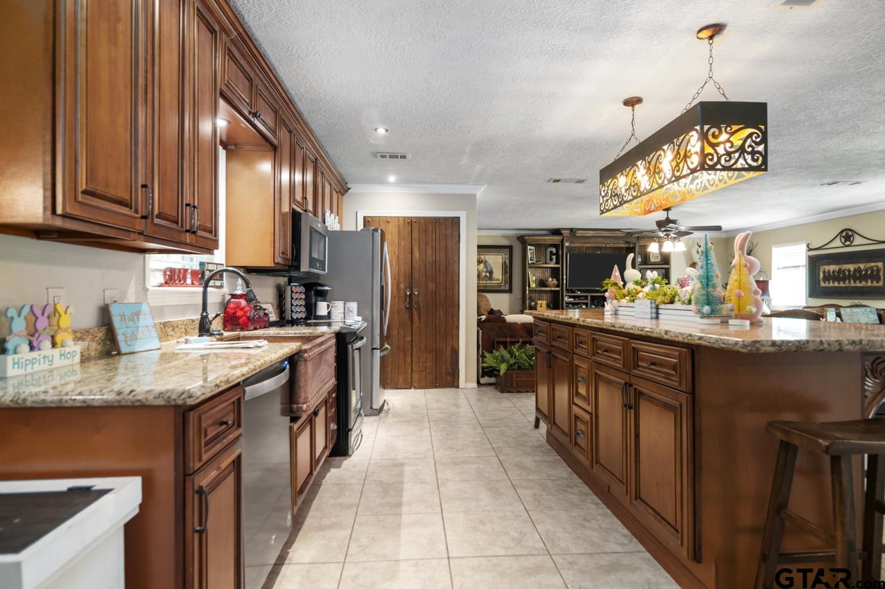 751 Houston Street Lovelady, TX 75851 - Photo 9 of 25 a kitchen with stainless steel appliances granite countertop a sink stove and refrigerator