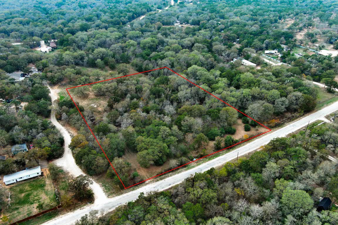235 The Forest Road Dale, TX 78616 - Photo 3 of 14 an aerial view of residential houses with outdoor space and trees