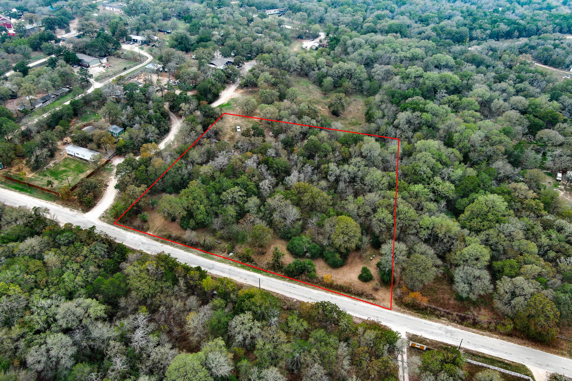 235 The Forest Road Dale, TX 78616 - Photo 5 of 14 Aerial view of property and surrounding area with property parcel outlined