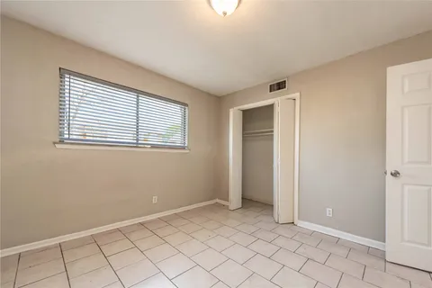 a view of a kitchen with white cabinets
