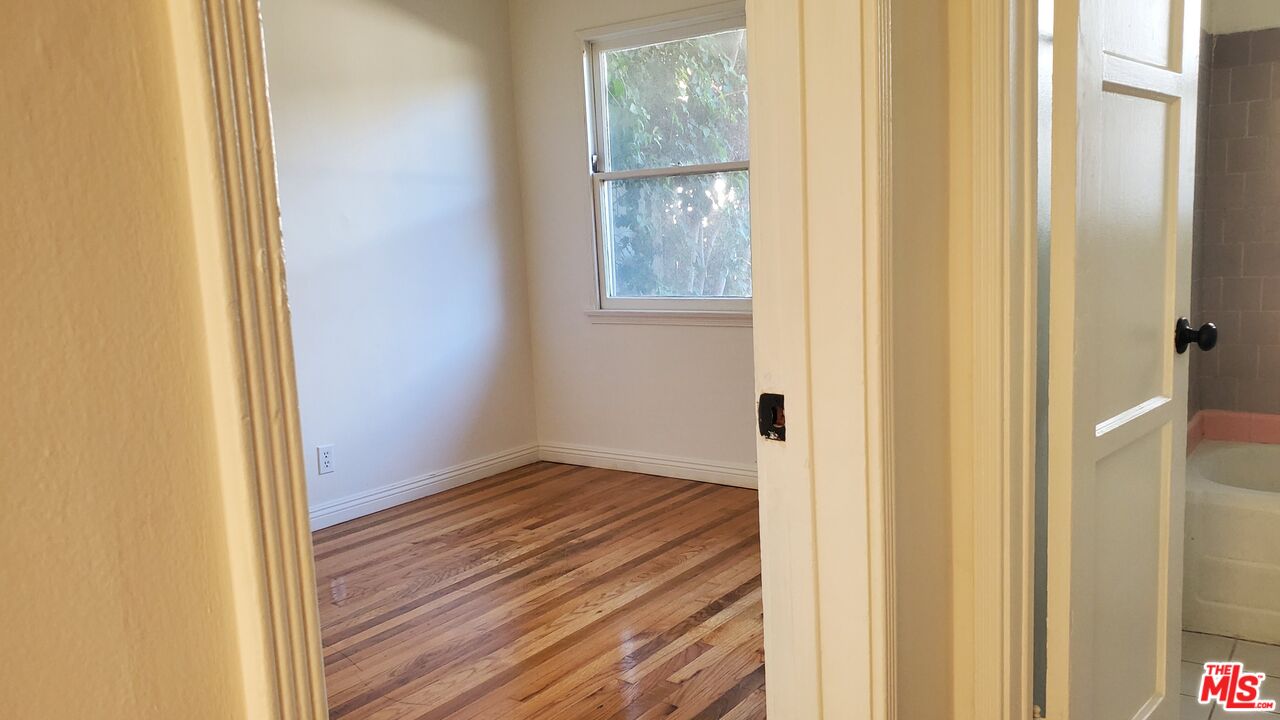 11202 Camarillo Street, Unit 11204 North Hollywood, CA 91602 - Photo 4 of 9 a view of a small space with wooden floor and a window