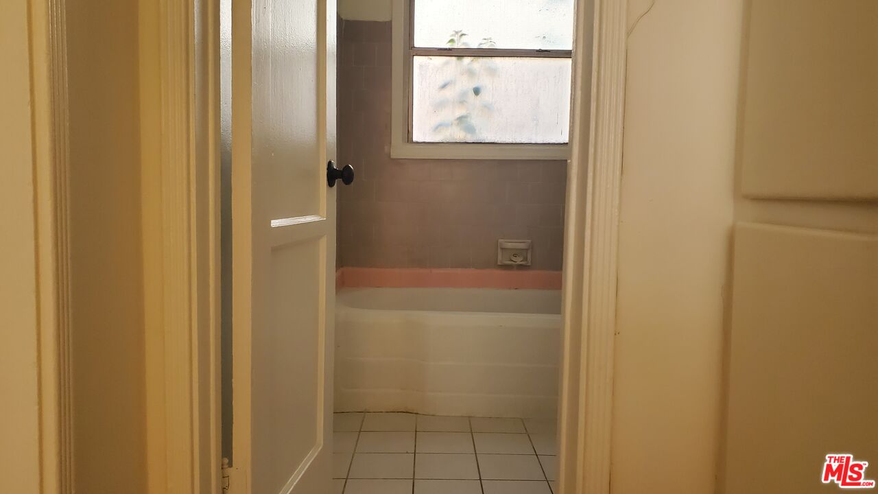 11202 Camarillo Street, Unit 11204 North Hollywood, CA 91602 - Photo 8 of 9 a bathroom with a glass shower door