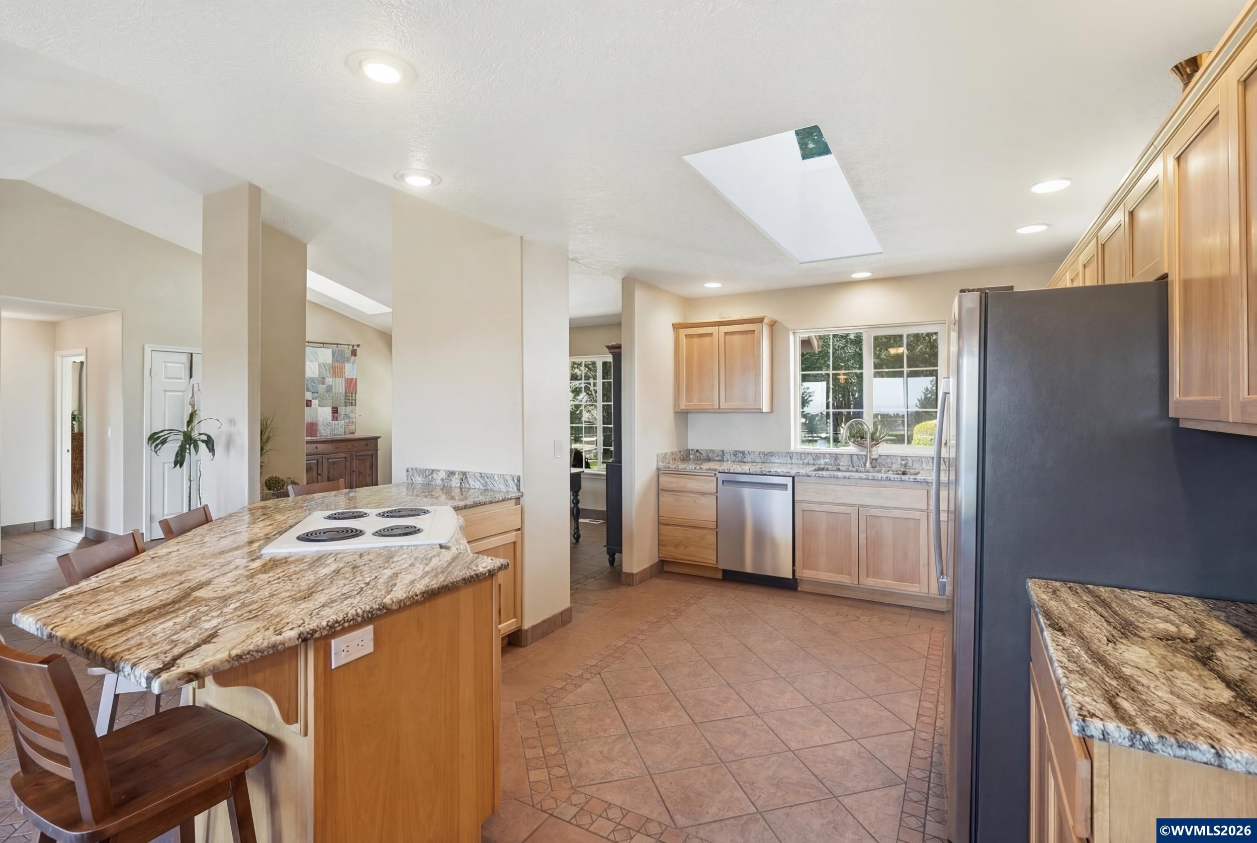 1110 Reuben Boise Road Dallas, OR 97338 - Photo 14 of 49 a kitchen with a table chairs refrigerator and a sink
