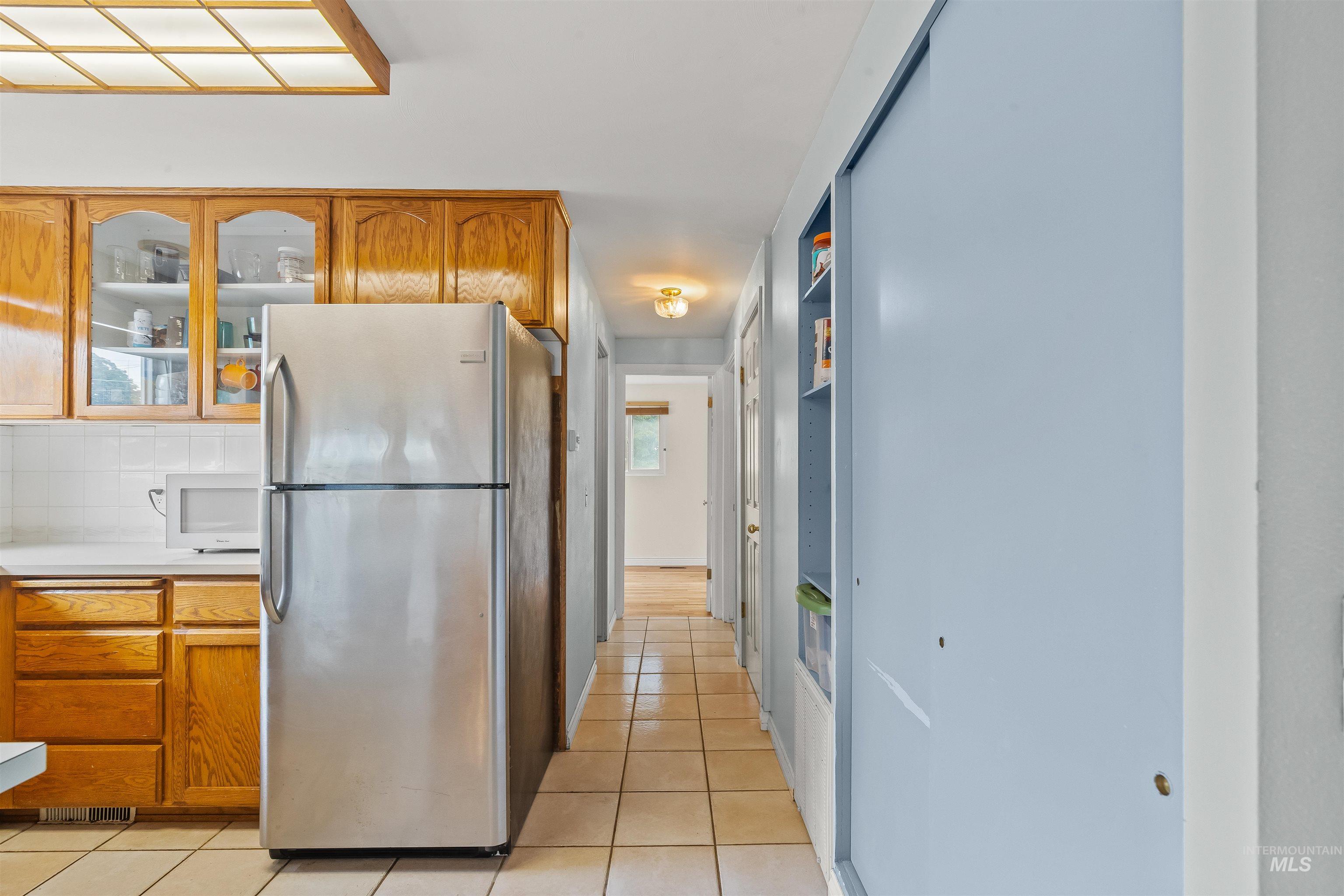 3620 18th Street Lewiston, ID 83501 - Photo 8 of 32 Kitchen area with wood-finish cabinetry, white tile backsplash, and a recessed ceiling light panel