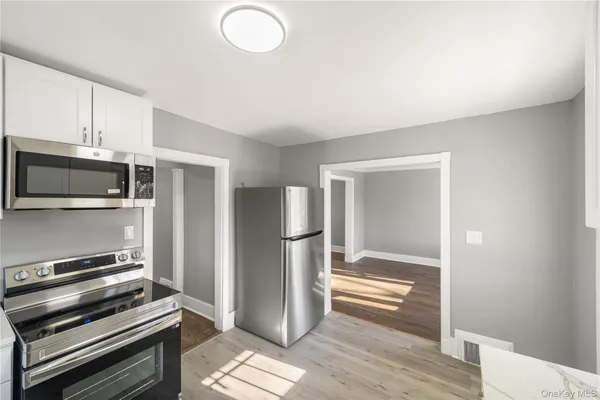 a kitchen with kitchen island a counter top space and stainless steel appliances
