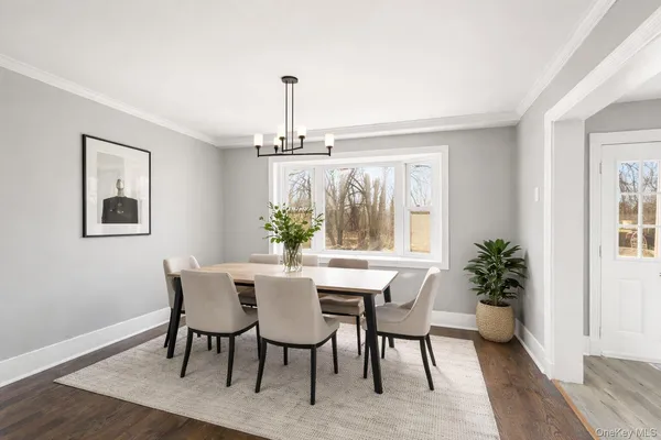 a view of a dining room with furniture window and wooden floor