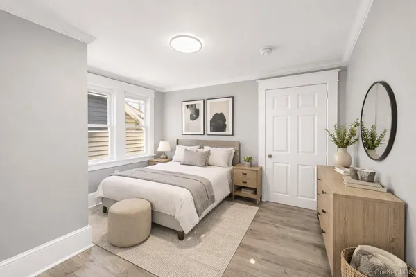 a bedroom with a bed a mirror and a window