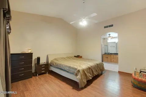 a bedroom with a bed and a mirror