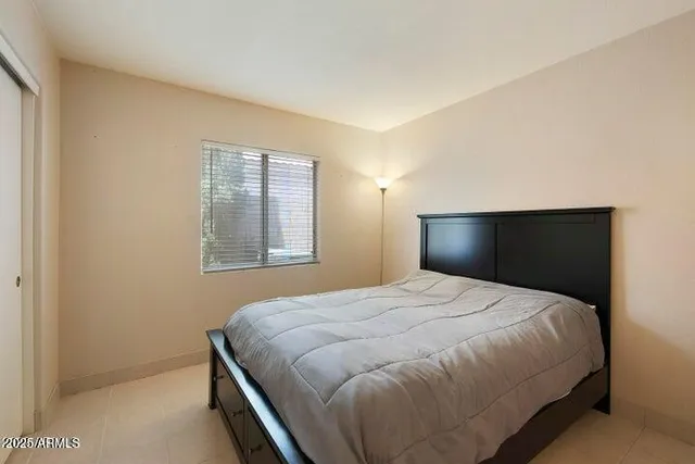 a bedroom with a bed and a window