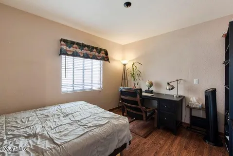 a bedroom with a bed and a desk