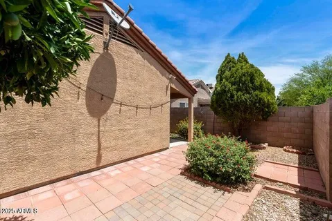 a view of a bird house next to yard