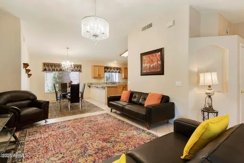 a living room with furniture a rug and a chandelier